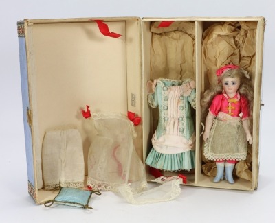 A rare miniature all bisque mignonette doll in trunk, French circa 1880,