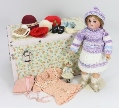 An S.F.B.J 60 bisque head doll in trunk,