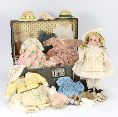 A sweet S.F.B.J 60 bisque head doll with trunk and trousseau,