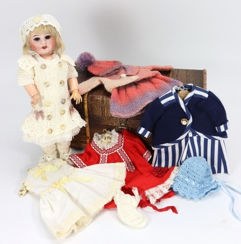 An S.F.B.J 60 bisque head doll with travel trunk,