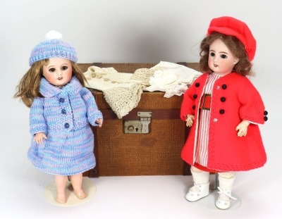 A Unis France 60 bisque head doll in trunk,