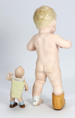 A bisque figurine of child playing in a shoe, German circa 1910, - 2