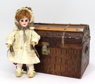 A miniature Simon & Halbig 749 bisque head doll in trunk,