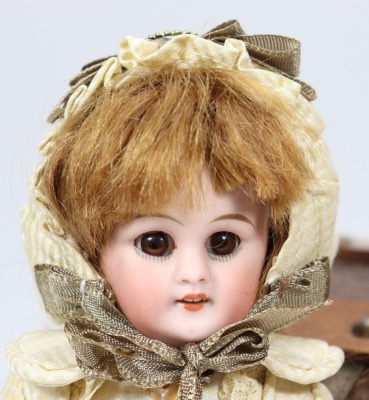A miniature Simon & Halbig 749 bisque head doll in trunk, - 2