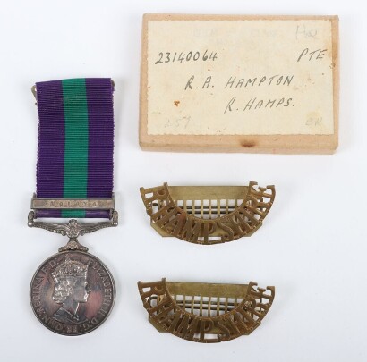 ERII General Service Medal to the Royal Hampshire Regiment with Malaya Clasp. Impressed to 23140064 Pte. R.A Hampton Royal Hampshire Regiment with its original box and pair of Royal Hampshire brass shoulder titles. (3)