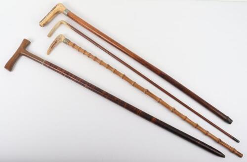 Two antler walking sticks, a horn handle stick and one other