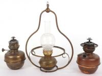 Two oil lamps, one with Campe Veritas badge