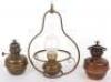 Two oil lamps, one with Campe Veritas badge
