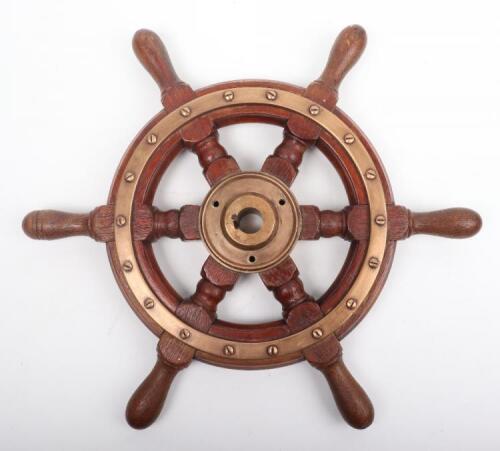 An early 20th century oak and brass ships wheel