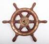 An early 20th century oak and brass ships wheel