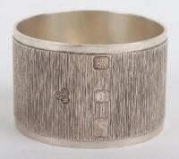 A modern silver napkin ring with textured body, Wakely & Wheeler, London modern