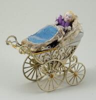 Miniature painted soft metal pram and doll, German circa 1890,