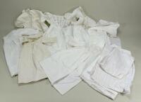 A good selection of white cotton dolls dresses, christening gowns and underclothes,
