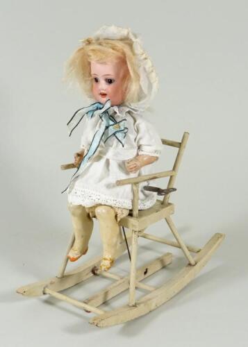 A sweet mechanical toy Doll seated in clockwork rocking chair, German circa 1905,