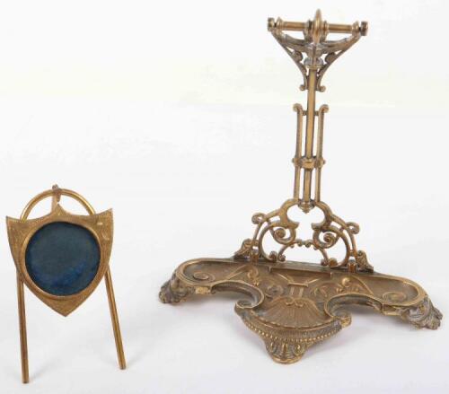 A 19th century gilt brass pocket watch stand on shield 10cmH