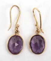 A pair of gold and amethyst drop pendant earrings