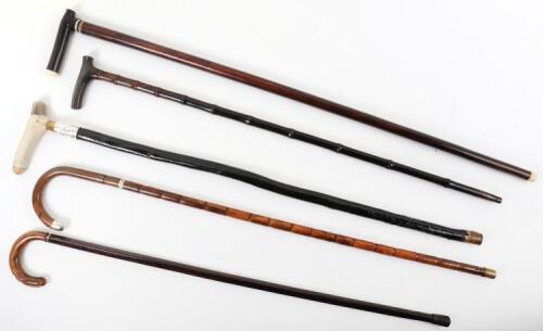 Five walking sticks, including a rosewood and banded stick