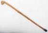 A rustic carved grotesque mask walking stick