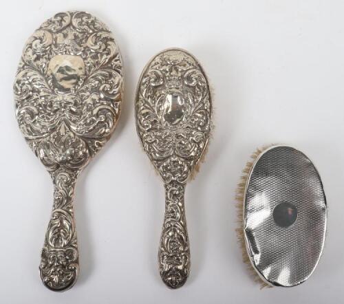 Three 20th century silver dress brushes