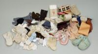 A collection of dolls socks, clothes and bonnets,