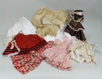 A collection of various dolls clothes,