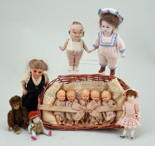 A small collection of miniature dolls and Schuco monkey, German mostly 1920s,