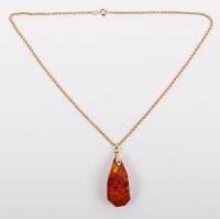 A 15ct gold chain with amber pendant
