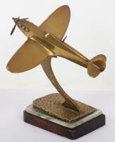 A brass model of a Spitfire in flight